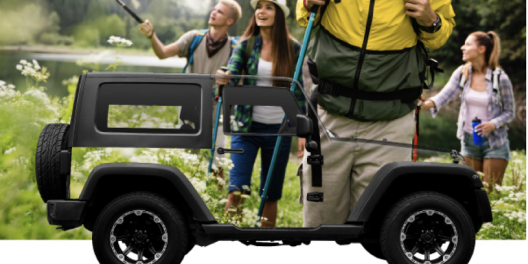 a man carrying a small vehicle with people standing around