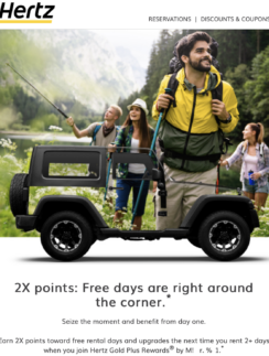 a man carrying a small vehicle with people standing around