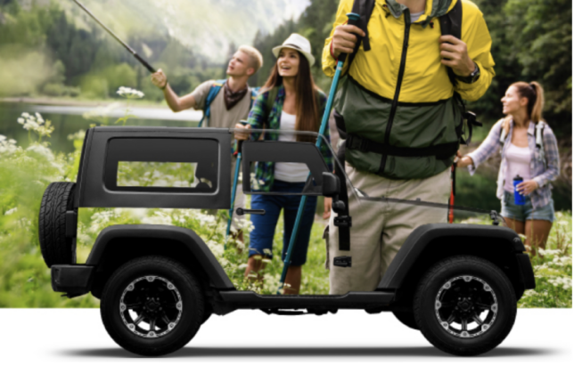 a man carrying a small vehicle with people standing around