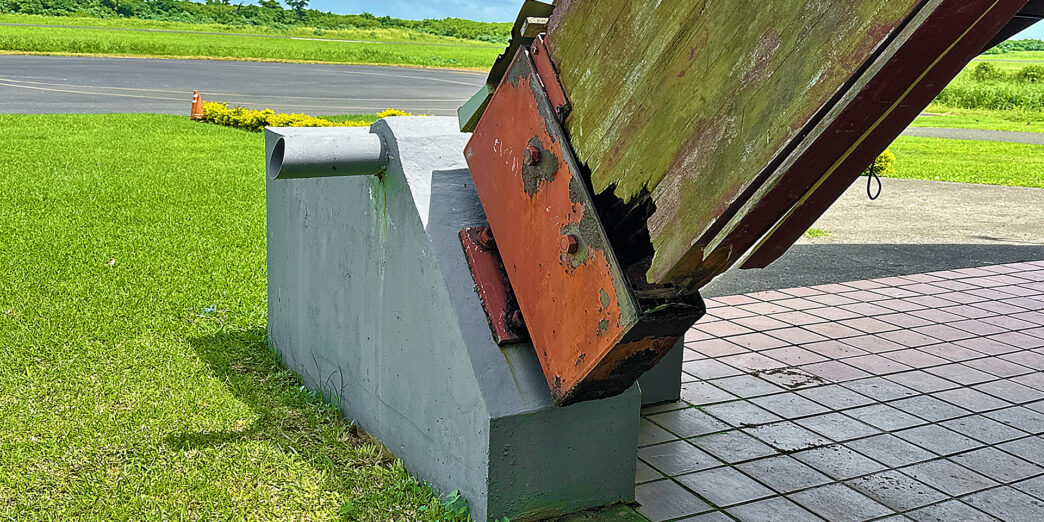 a large metal object with a rusted metal piece on top
