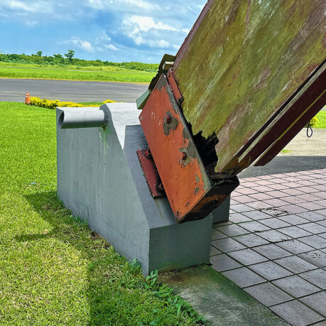 a large metal object with a rusted metal piece on top
