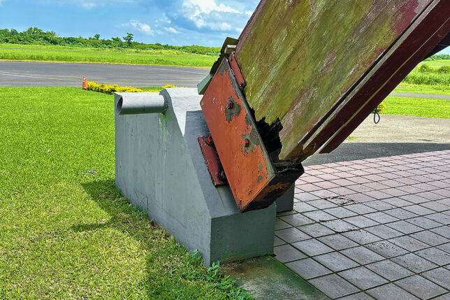 a large metal object with a rusted metal piece on top
