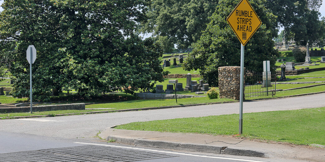 a yellow sign on a pole