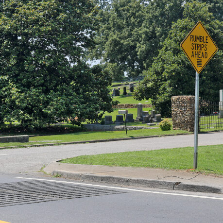 a yellow sign on a pole