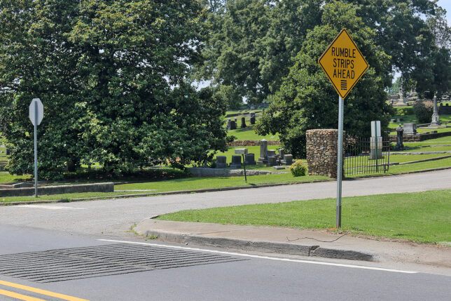 a yellow sign on a pole