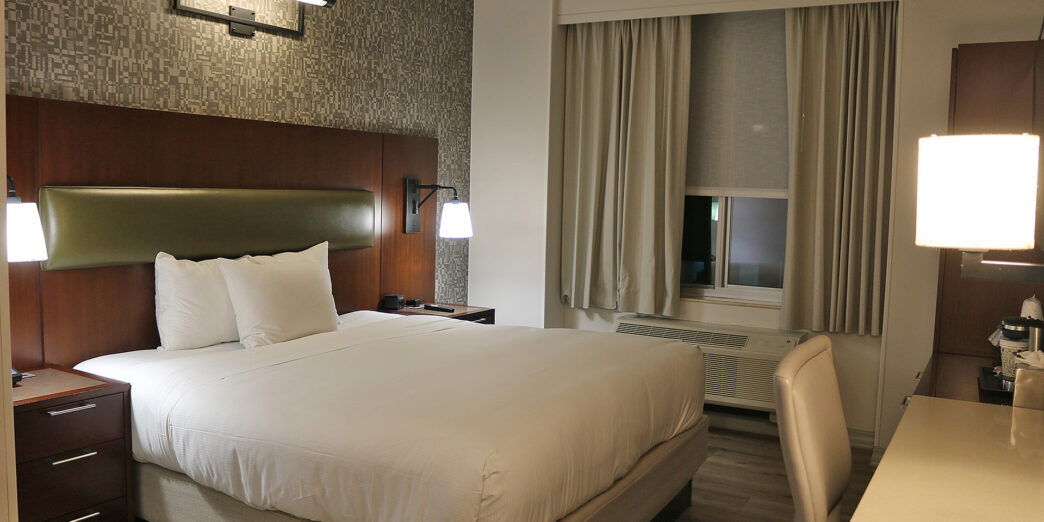 a bed with a lamp and a table