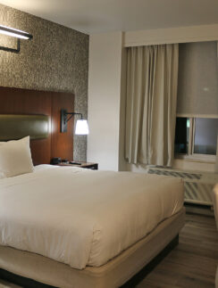 a bed with a lamp and a table