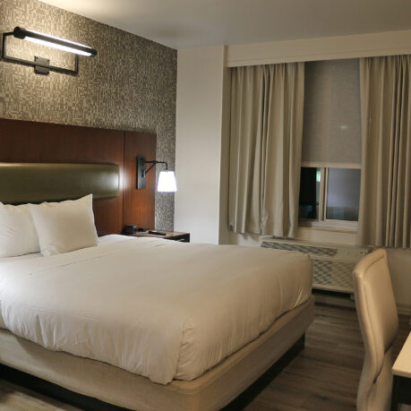 a bed with a lamp and a table
