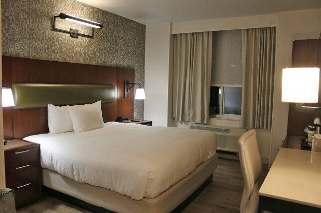 a bed with a lamp and a table