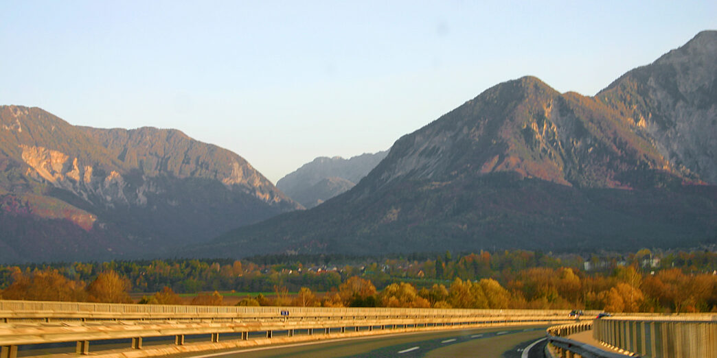 a road with a mountain range in the background
