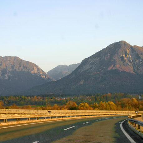 a road with a mountain range in the background