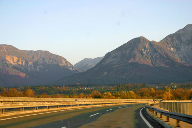 a road with a mountain range in the background