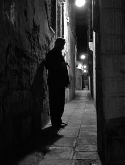 a man standing in a dark alley