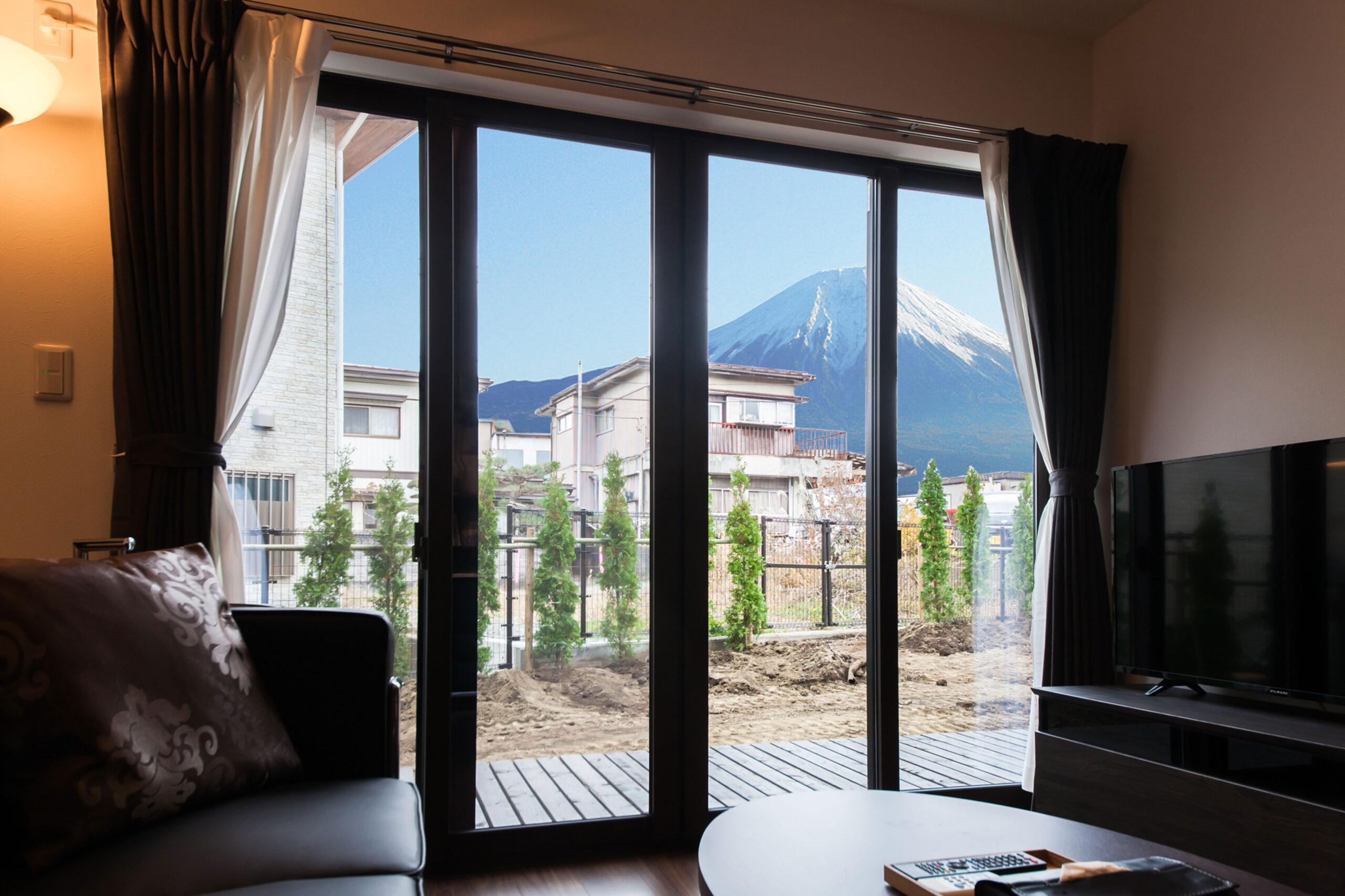 a room with a view of a mountain and a couch