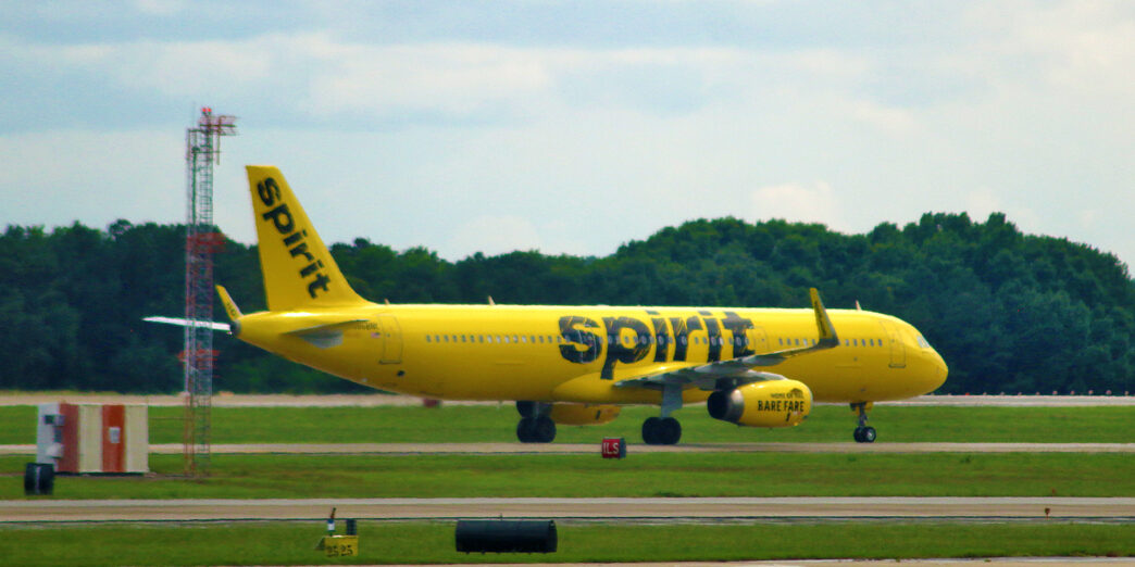 a yellow airplane on a runway
