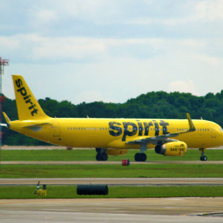 a yellow airplane on a runway
