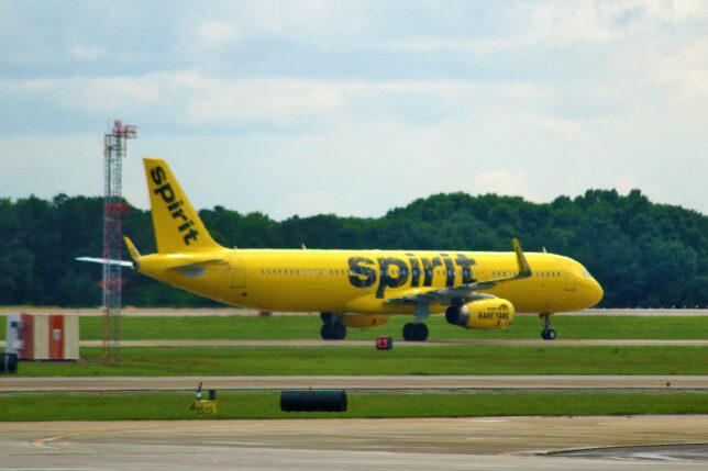 a yellow airplane on a runway