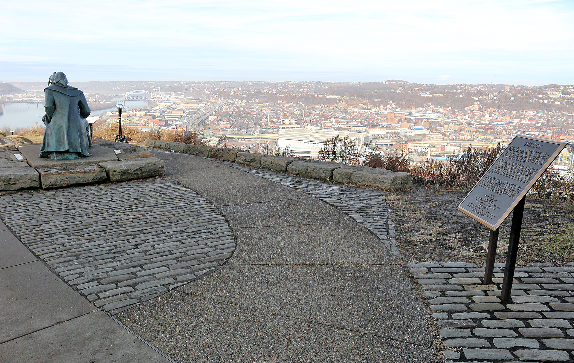 a paved path with a view of a city