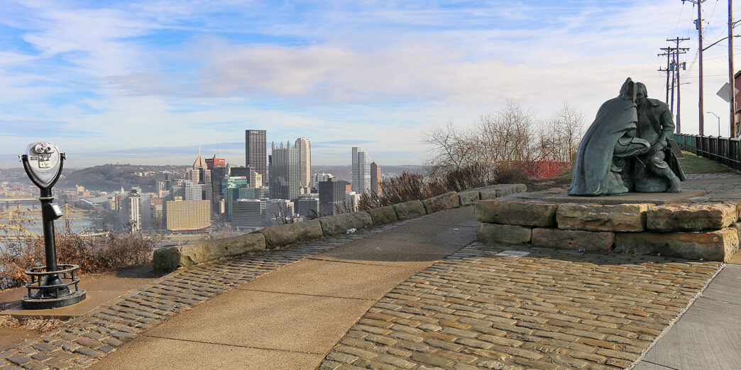 a stone walkway with a statue on top of it