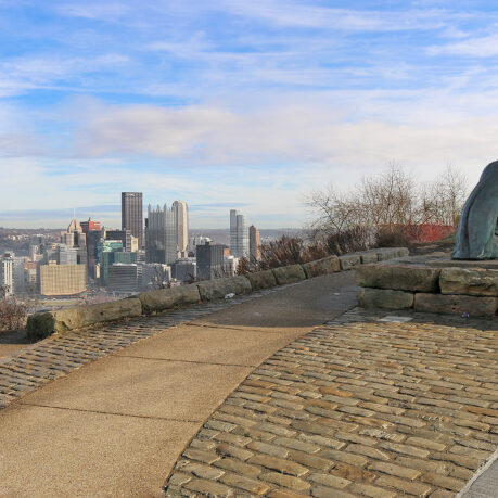 a stone walkway with a statue on top of it