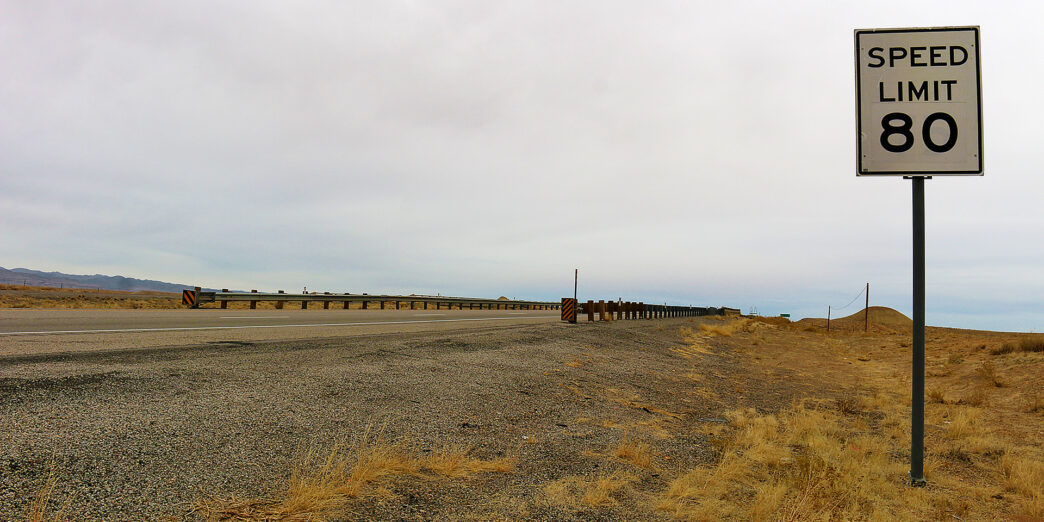 a road sign on a gravel road