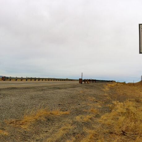 a road sign on a gravel road