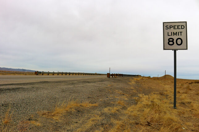 a road sign on a gravel road