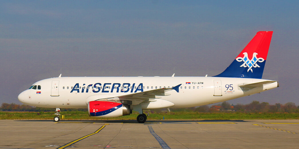 a white airplane on a runway