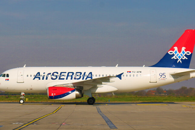 a white airplane on a runway
