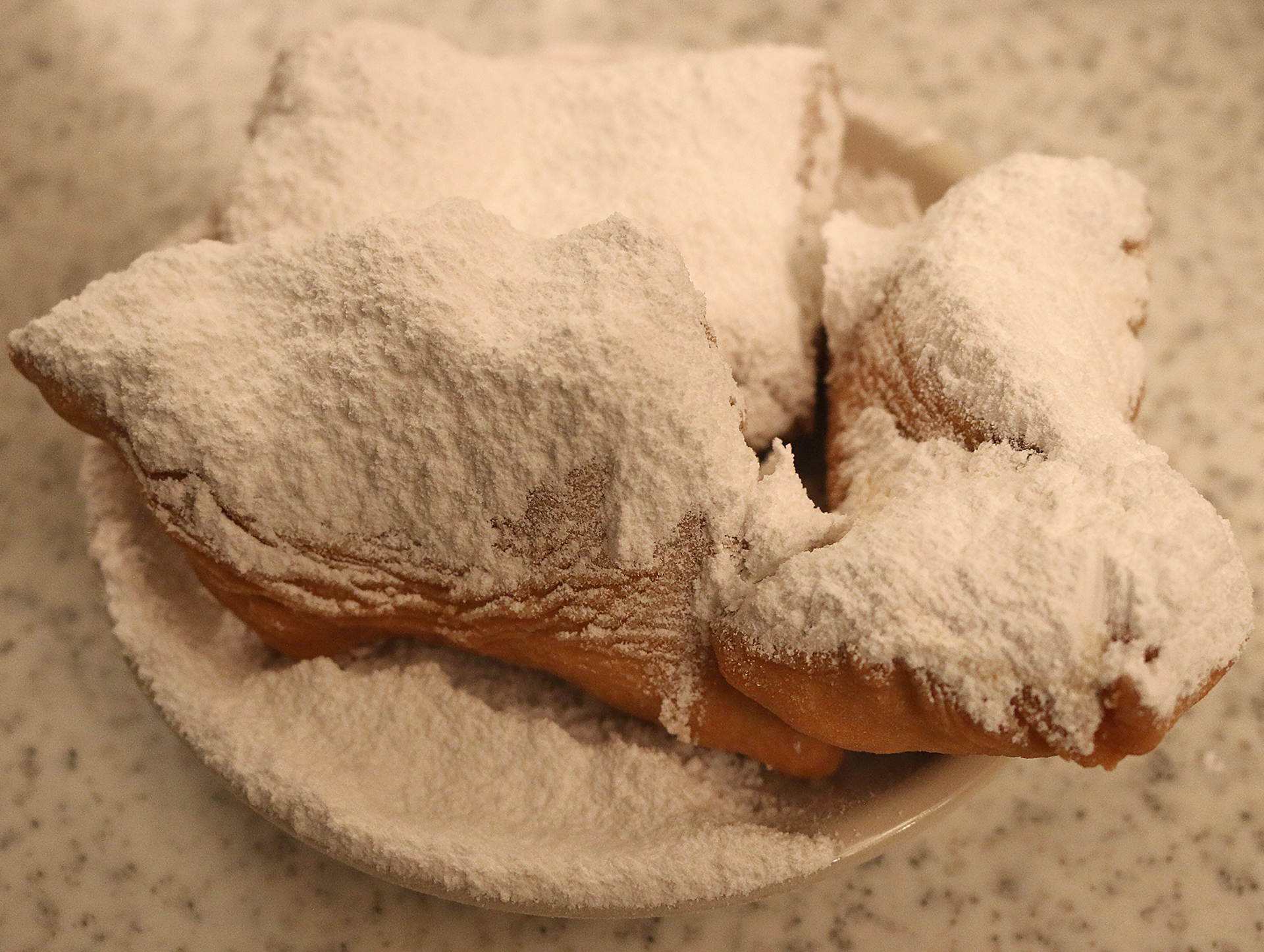 a plate of food with powdered sugar on it