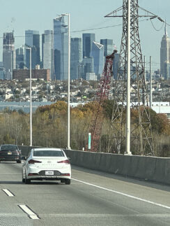 cars on a road with a city in the background