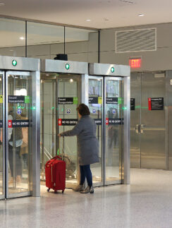 a group of people standing in front of glass doors