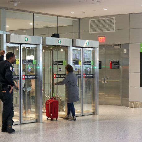 a group of people standing in front of glass doors