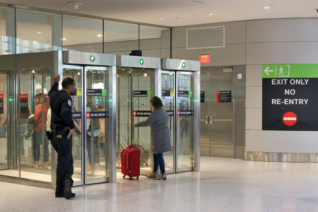 a group of people standing in front of glass doors