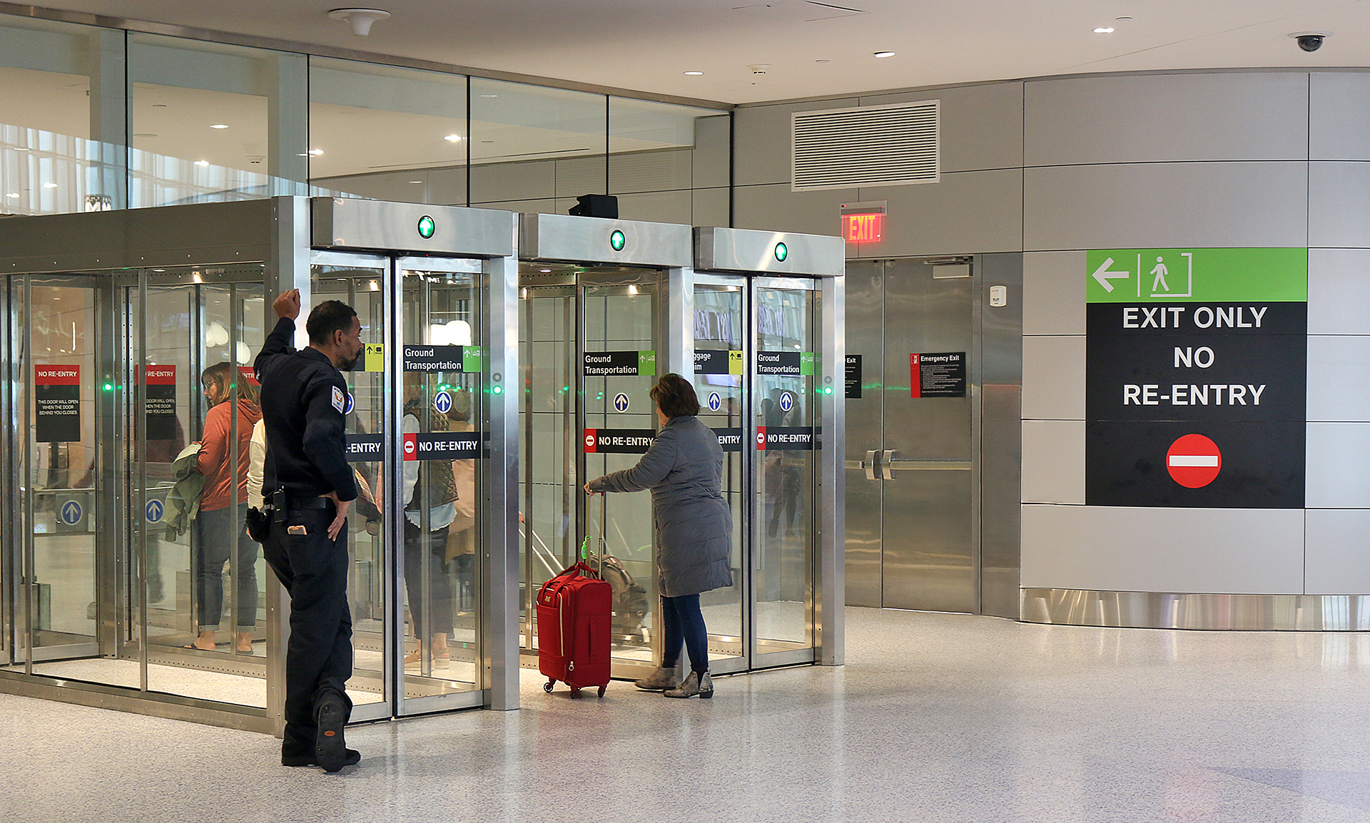 a group of people standing in front of glass doors