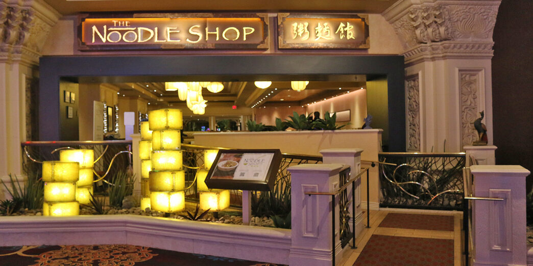 a building with a sign and a railing