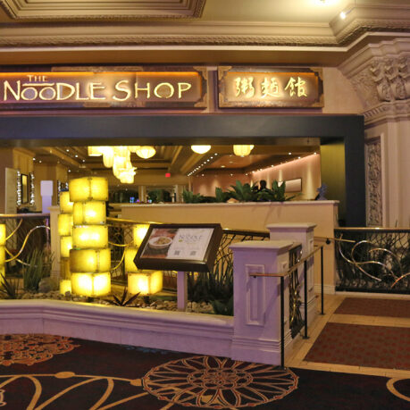 a building with a sign and a railing