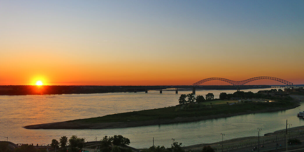 a sunset over a river