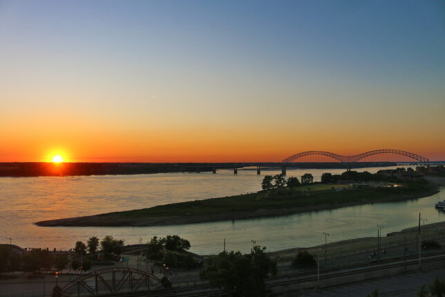 a sunset over a river