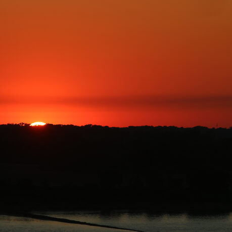 a sunset over a body of water