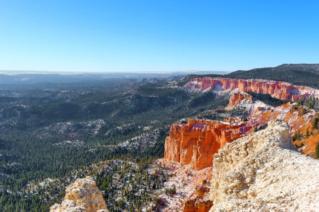 a red cliffs and trees in the distance
