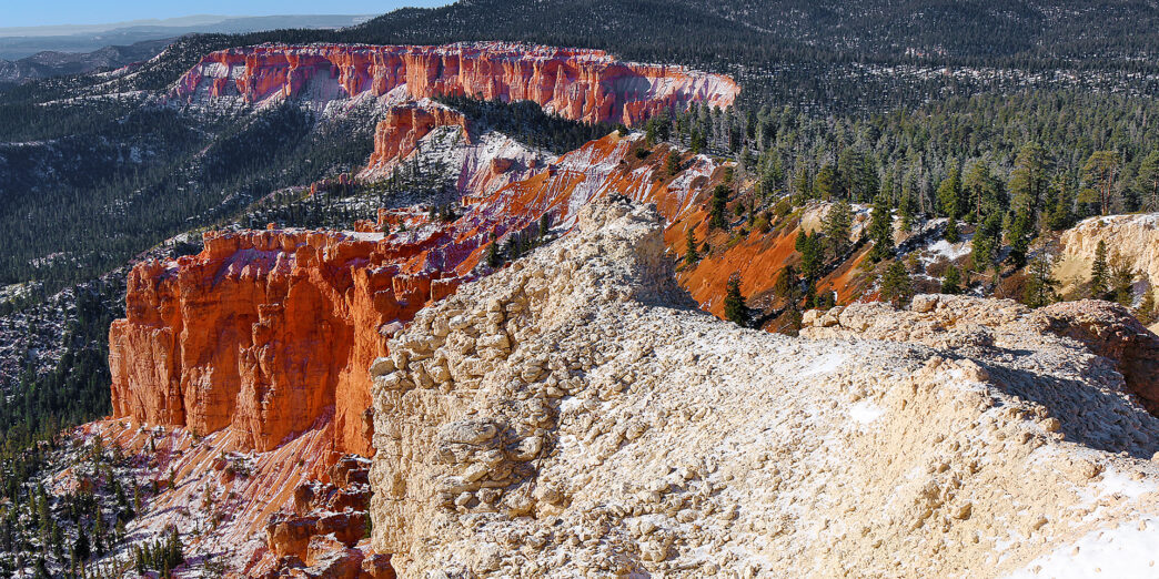 a snow covered mountain with trees