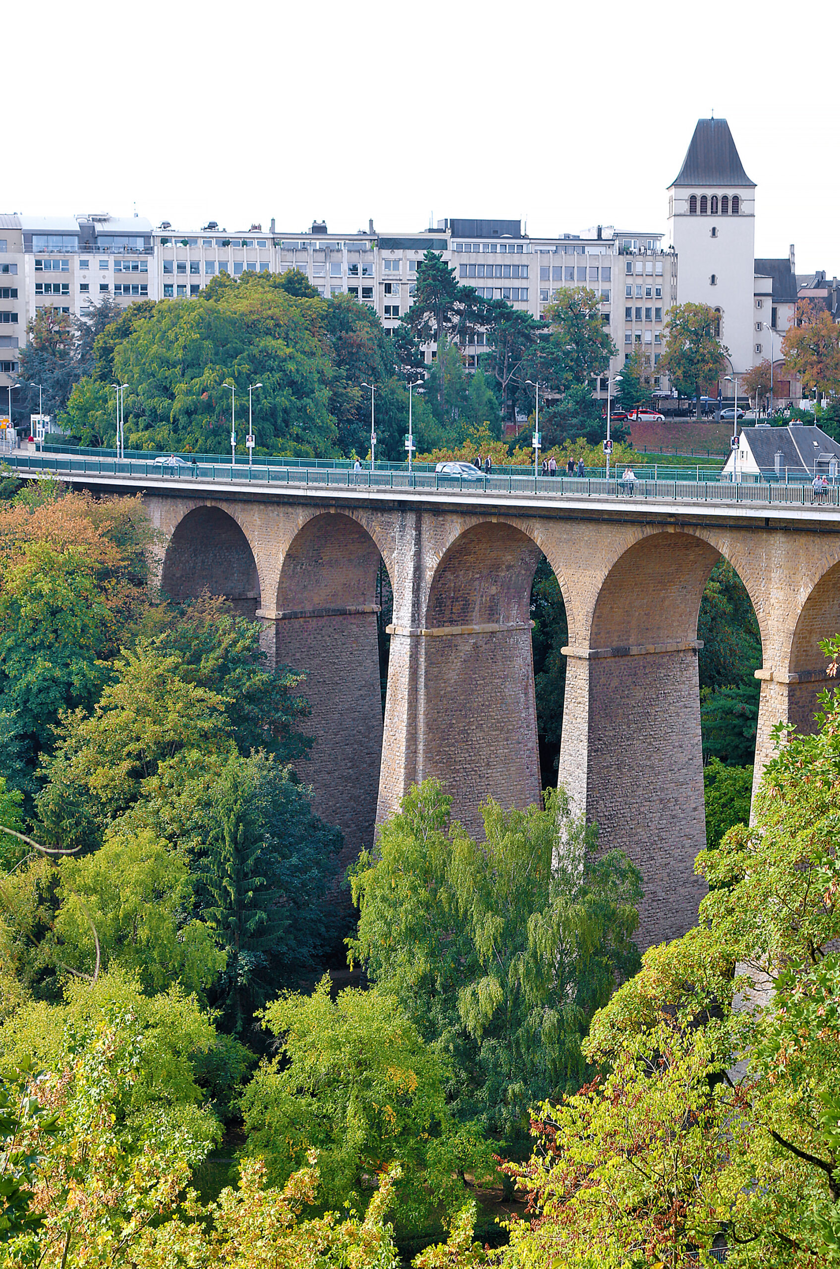 a bridge with many arches and trees