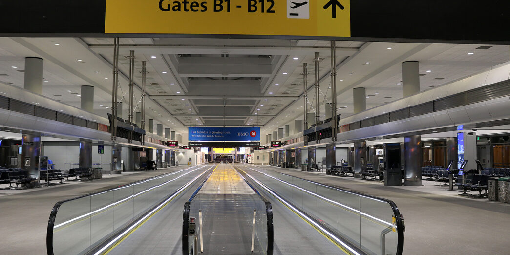 an empty airport with an escalator
