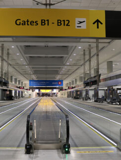 an empty airport with an escalator