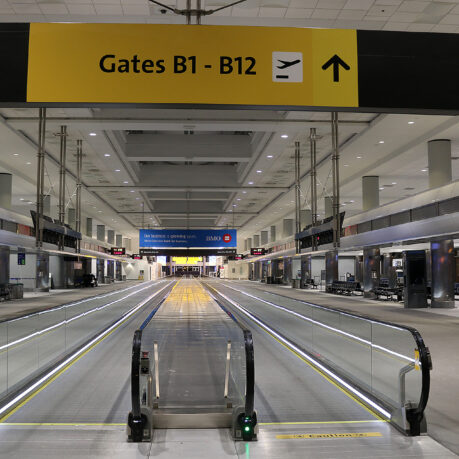 an empty airport with an escalator
