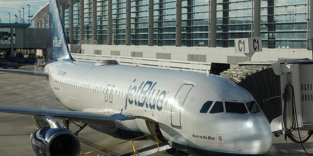 a jet plane parked in front of a building