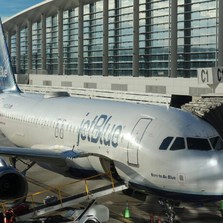 a jet plane parked in front of a building