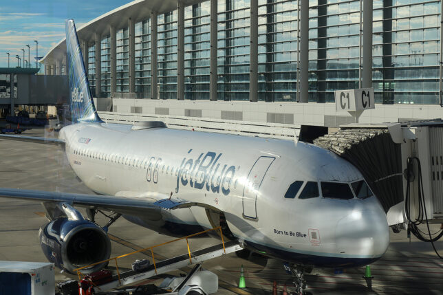 a jet plane parked in front of a building