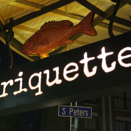 a sign with a fish and a street sign